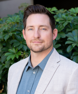 Our team member, Professional headshot of Maxwell Shenk, Chief Operating Officer of ACI Apartments, wearing a blazer and looking confident yet approachable.