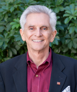 Our team member, Professional headshot of Terry Moore, Principal at ACI Apartments, wearing a suit and smiling.